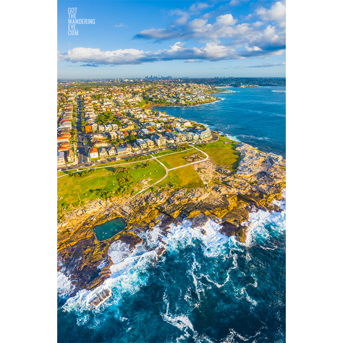 Aerial seascape above Mahon Pool, Mistral Point looking back to the Sydney city skyline by Allan Chan