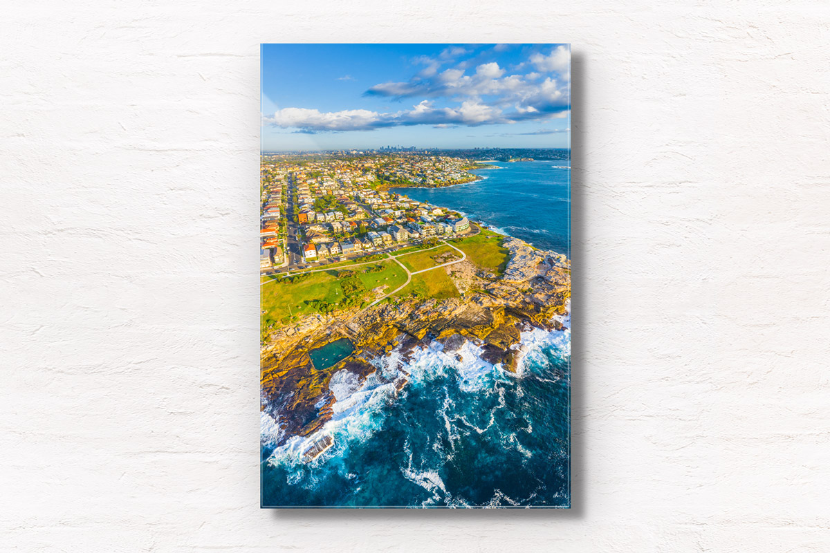Aerial seascape above Mahon Pool, Mistral Point looking back to the Sydney city skyline by Allan Chan