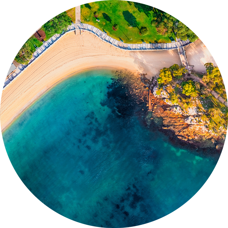 Ocean Aerial Balmoral Beach. ChromaLuxe round metal prints of Sydneys beaches. Aerial oceanscape above Balmoral Beach promenade in the morning. Wall art delivered and ready to hang.