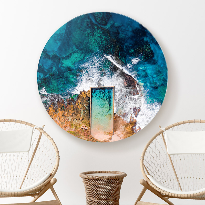 ChromaLuxe round metal wall art ocean prints. Aerial oceanscape above North Cronulla rockpool, as waves crash over from the beach. Wall art delivered and ready to hang.