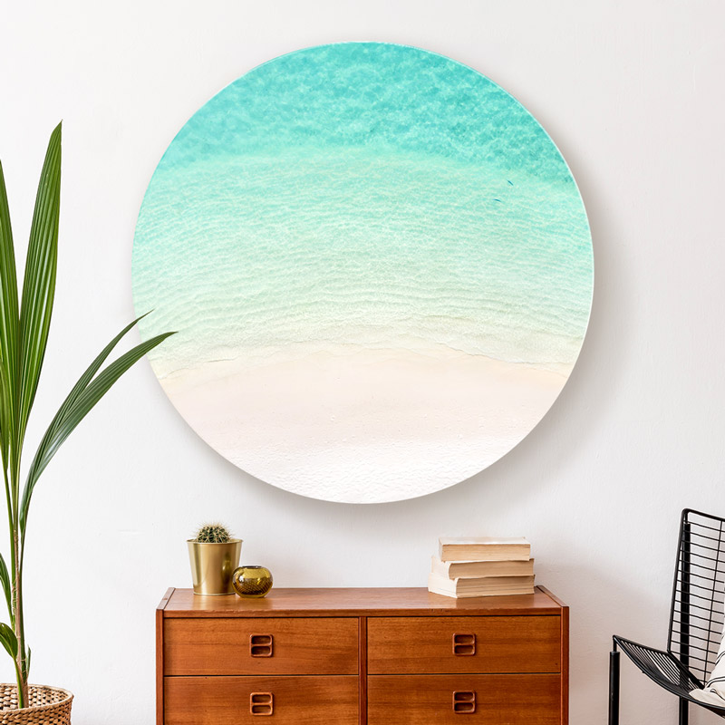 ChromaLuxe round metal wall art ocean prints. Aerial oceanscape above crystal clear ocean in the island paradise of the Maldives. Wall art delivered and ready to hang.