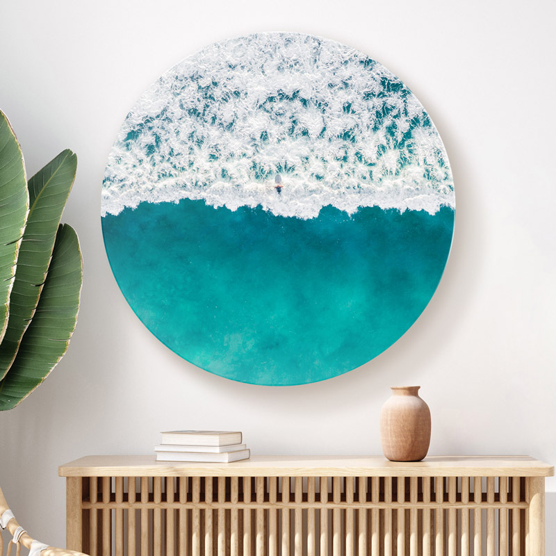 ChromaLuxe round metal wall art ocean prints. A lone surfer sits on the crest of a wave in Maroubra Beach.