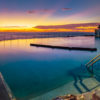Gorgeous rainbow coloured sunrise over an empty Bronte Baths Rockpool
