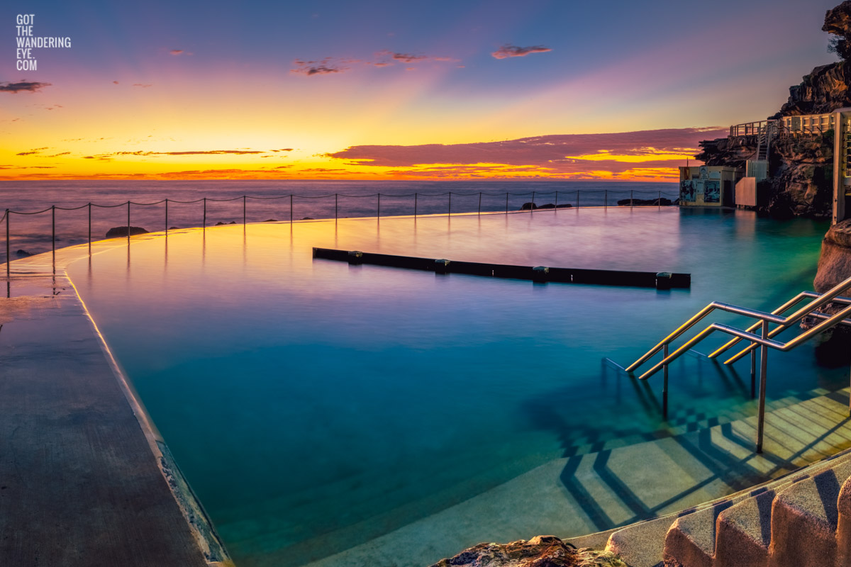 Gorgeous rainbow coloured sunrise over an empty Bronte Baths Rockpool