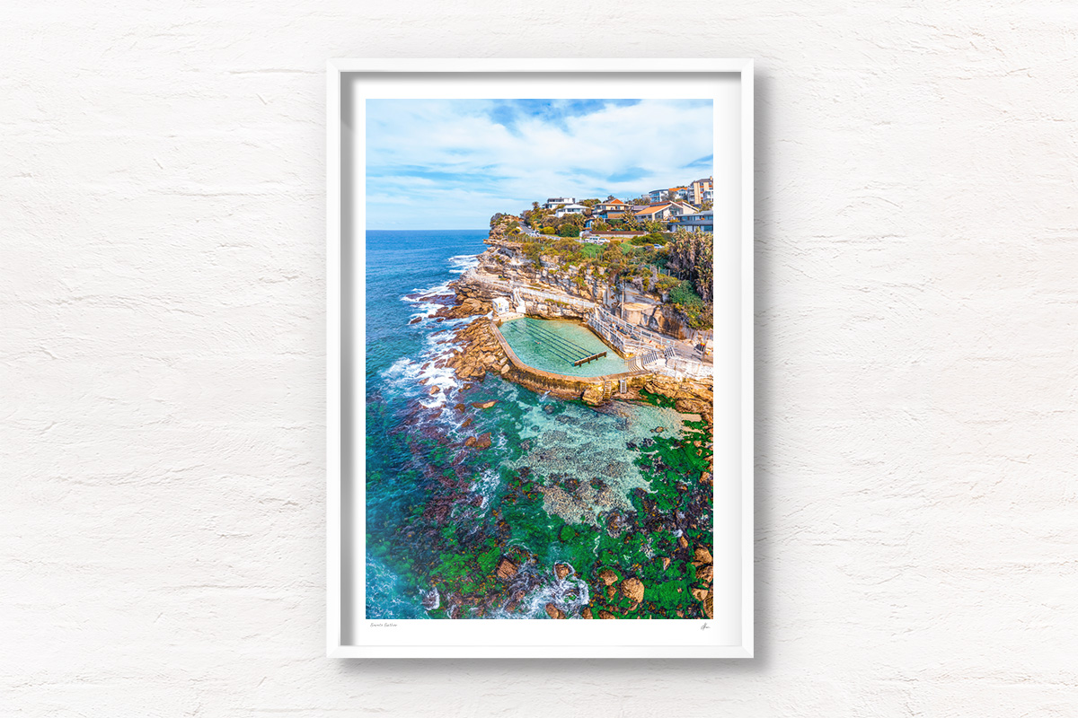Framed wall print of a swimming in bronte rockpool, bronte baths on a sunny day at at low tide