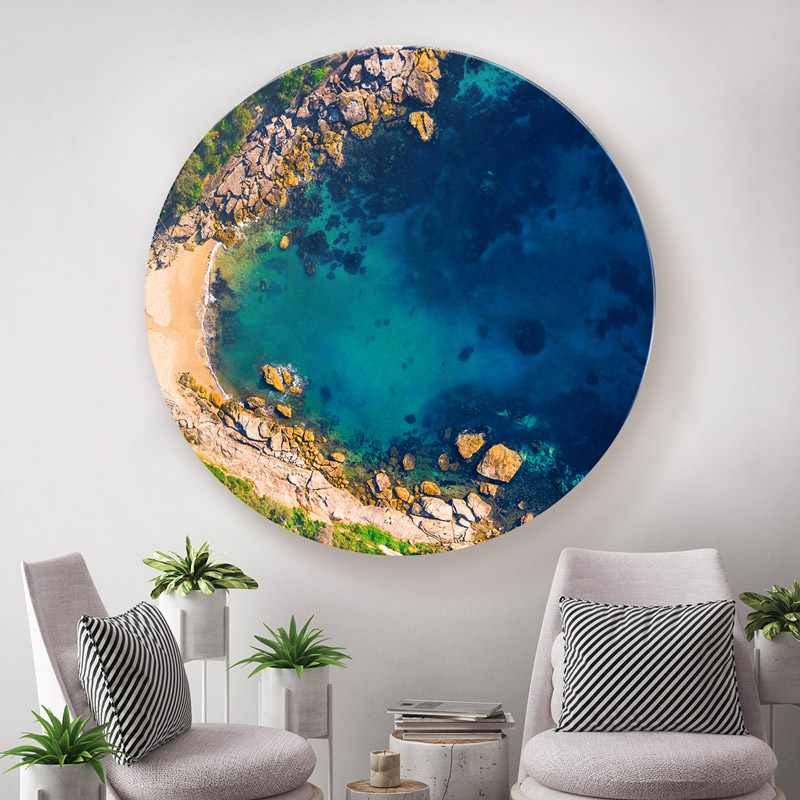 ChromaLuxe round metal wall art ocean prints. Aerial oceanscape above the secluded bay of the eastern suburbs Gordons Bay. ChromaLuxe round metal print of the ocean. Aerial oceanscape above a woman enjoying a slither of the Sutherland Shires Cronulla Beach. Wall art delivered and ready to hang.