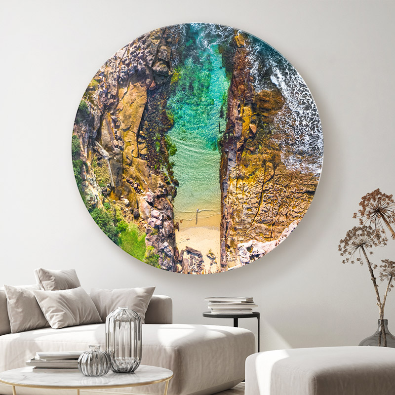 ChromaLuxe round metal wall art ocean prints. Aerial oceanscape above a woman enjoying a slither of the Sutherland Shires Cronulla Beach. Wall art delivered and ready to hang.