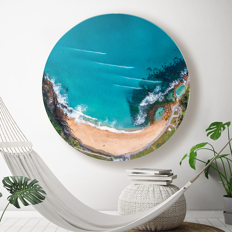 Round chromaLuxe metal print high above Bronte Beach & Rockpool, hanging in a coastal home.