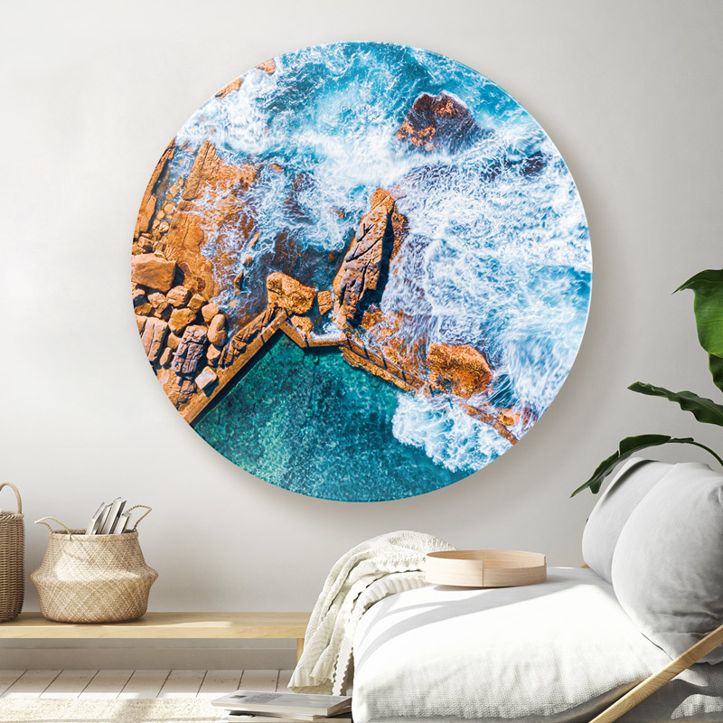 ChromaLuxe metal circle print of the ocean overflowing into Mahon Pool, Maroubra. Hanging in modern loungeroom.