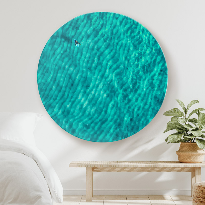 ChromaLuxe round metal print of a surfer waiting for a wave with sand ripples underneath. Relaxing wall print for the bedroom.