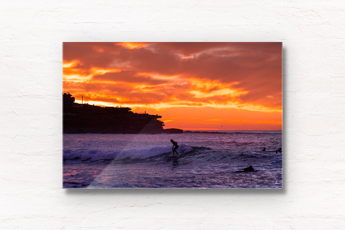 Framed acrylic wall art Surfer on a small wave with a scorching fiery sunrise over Ben Buckler at Bondi Beach
