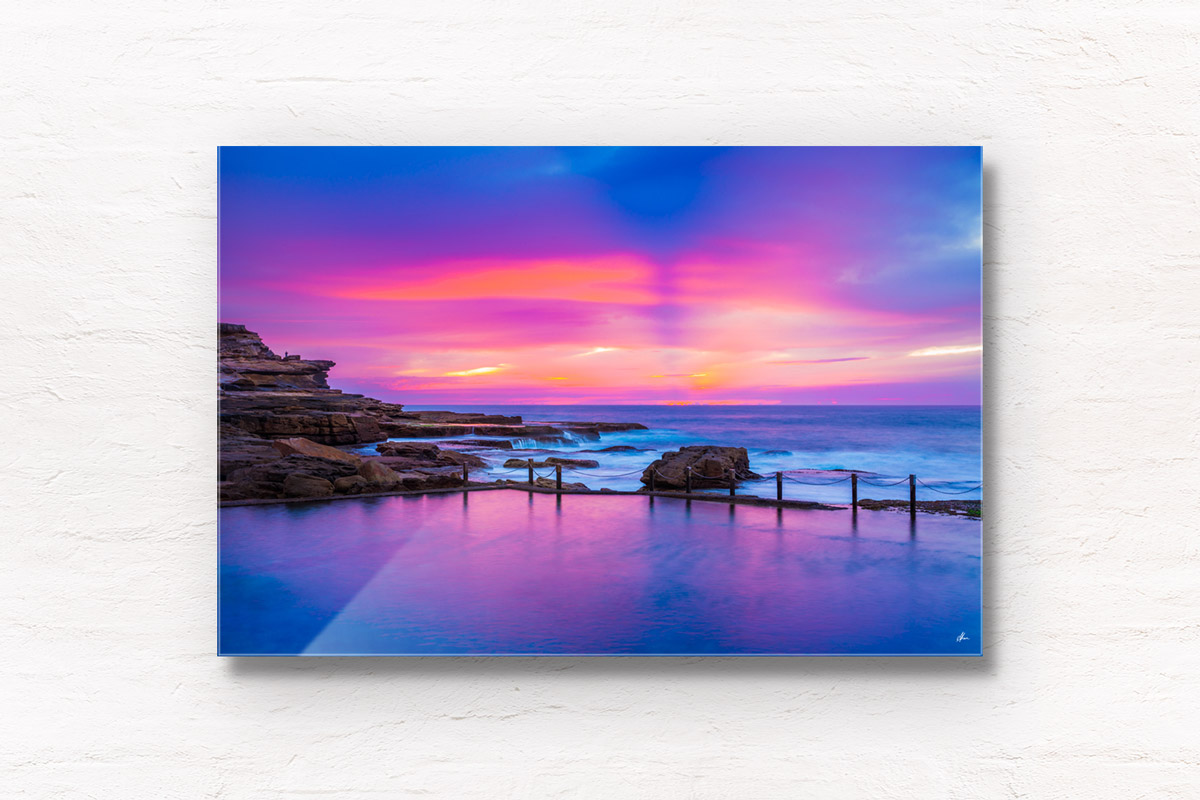 Framed wall art print of a pink and purple aurora sky, over a empty still Mahon Pool, Maroubra