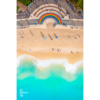Vibrant 50 metre long rainbow on the promenade curving around the Coogee steps, as swimmers walk along the beach.