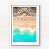 Vibrant 50 metre long rainbow on the promenade curving around the Coogee steps, as swimmers walk along the beach.