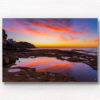 Incredible whispy pink and orange sunrise sky reflected and mirrored in the pool of water at Tamarama Beach.