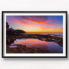 Incredible whispy pink and orange sunrise sky reflected and mirrored in the pool of water at Tamarama Beach.