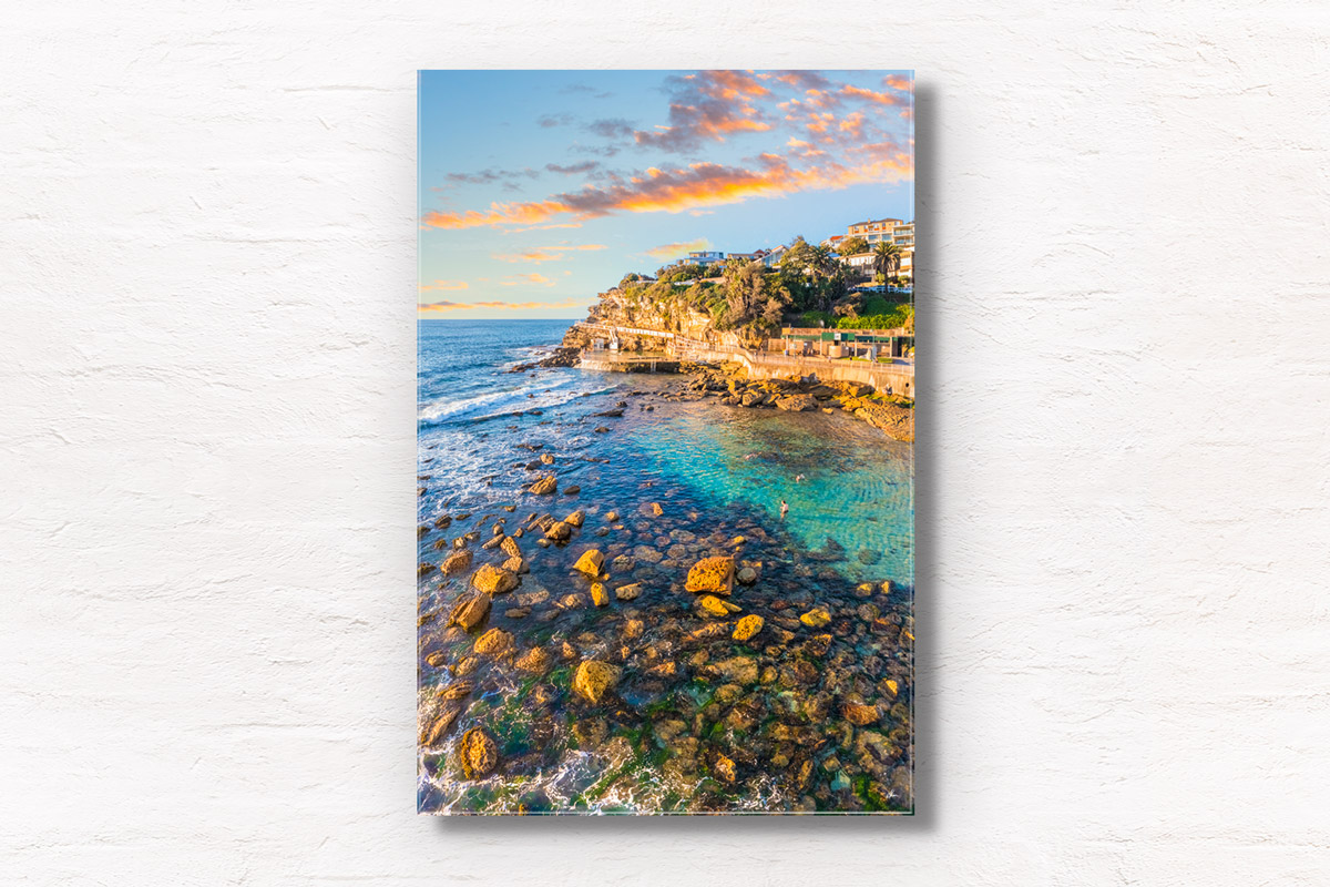 Swimmers enjoying the iconic swimming hole during golden hour in the morning at Bronte Beach Bogey hole Sydney. Wall art print by Allan Chan/