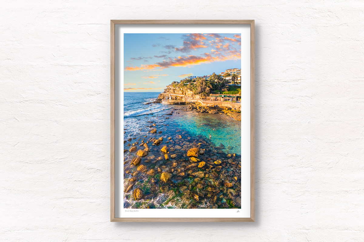 Swimmers enjoying the iconic swimming hole during golden hour in the morning at Bronte Beach Bogey hole Sydney. Wall art print by Allan Chan/