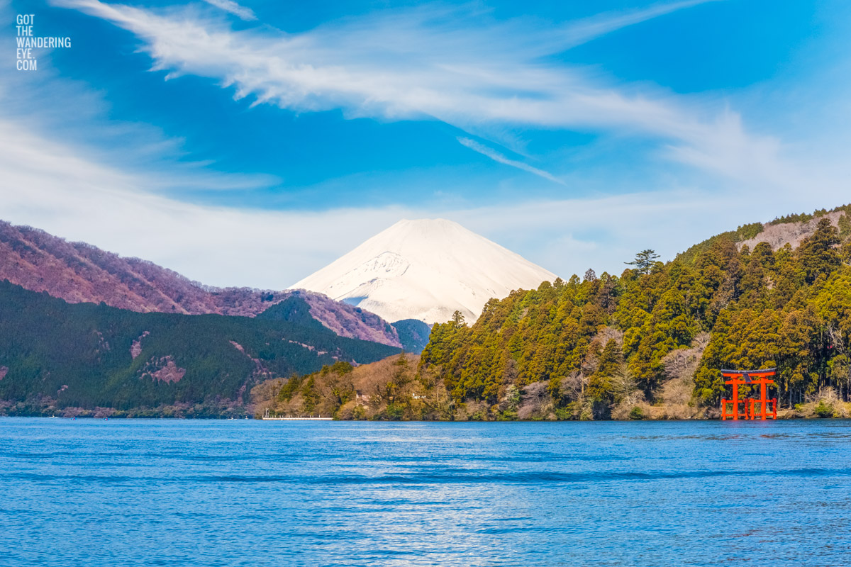 Beautiful clear day showcasing a snowcapped Mount Fuji and Hakone Shrine on Lake Ashinoko, also referred to as Hakone Lake or Ashinoko Lake.