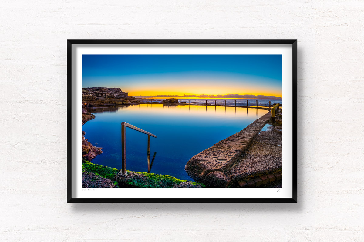 Sunrise at Sydney's Best Ocean Pool. Reflections on an empty still rock pool at Mahon Pool Maroubra by Allan Chan.