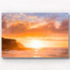 Golden warm light beaming through clouds on a Tamarama Beach Sydney Sunrise, lighting up Mackenzies point clifftops by Allan Chan.