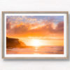 Golden warm light beaming through clouds on a Tamarama Beach Sydney Sunrise, lighting up Mackenzies point clifftops by Allan Chan.