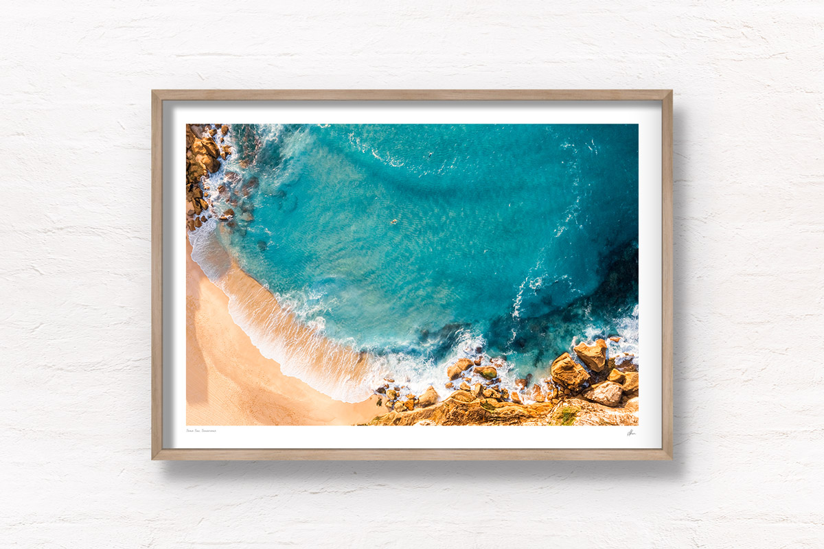 Surfing Tamarama Beach. Aerial view above surfers paddling out on the eastern suburbs best surfing beaches in Sydney. Wall Art Print.