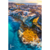 Waterfront North Bondi Aerial over flat rock overlooking North Bondi boat ramp during a warm sunny morning sunrise.