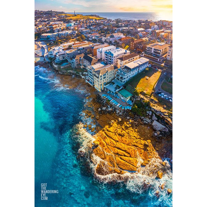 Waterfront North Bondi Aerial over flat rock overlooking North Bondi boat ramp during a warm sunny morning sunrise.