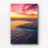 Aerial view above a Bondi Beach Sunset over the Sydney CBD skyline, glowing colour on the ocean waves.
