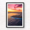Aerial view above a Bondi Beach Sunset over the Sydney CBD skyline, glowing colour on the ocean waves.