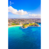 Aerial birds eye view looking back towards the Coogee Cliffs and dolphin point in Sydney. Clear blue sky summers day.