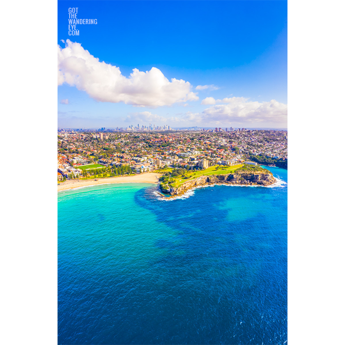 Aerial birds eye view looking back towards the Coogee Cliffs and dolphin point in Sydney. Clear blue sky summers day.