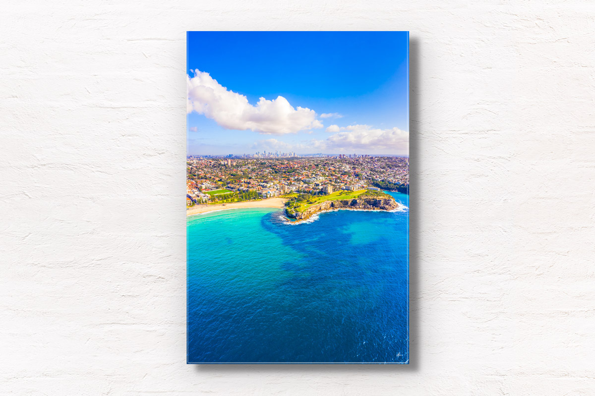 Aerial birds eye view looking back towards the Coogee Cliffs and dolphin point in Sydney. Clear blue sky summers day.