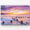 Cotton candy puffy pink clouds at a beautiful Sunrise at Coogee Beach from Ross Jones memorial ocean pool in Sydney.