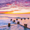 Cotton candy puffy pink clouds at a beautiful Sunrise at Coogee Beach from Ross Jones memorial ocean pool in Sydney.