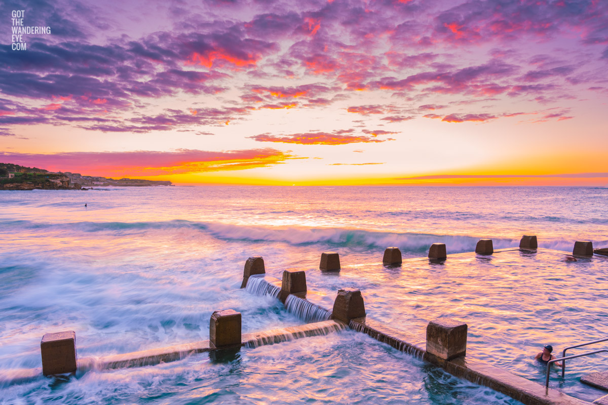 Cotton candy puffy pink clouds at a beautiful Sunrise at Coogee Beach from Ross Jones memorial ocean pool in Sydney.