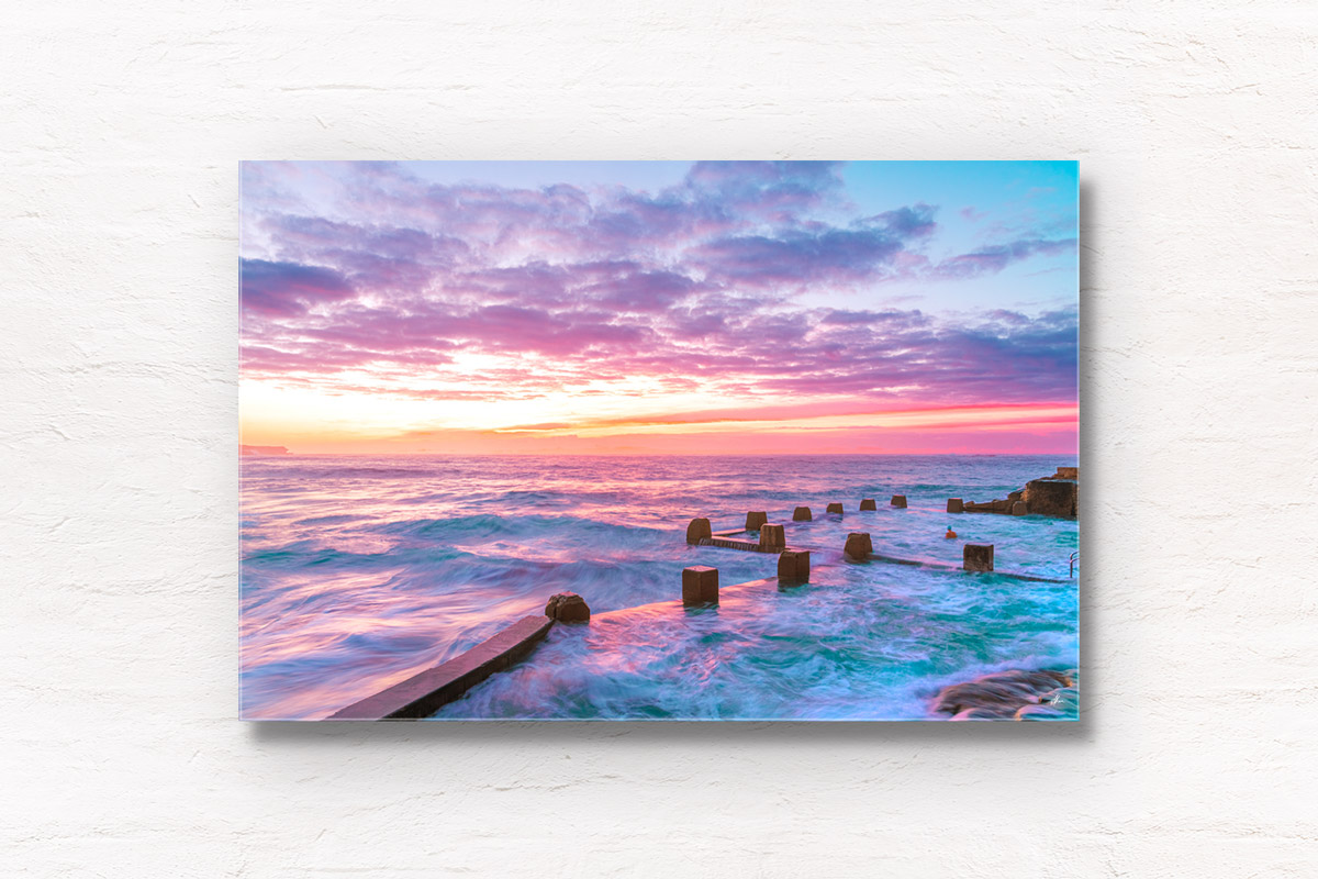 Colourful Coogee Beach Sunrise, long exposure photography of waves flowing in and over Ross Jones Memorial Rock Ocean Pool.