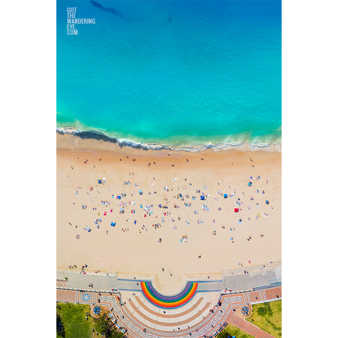 Aerial view above Coogee Beach Rainbow Walkway during a packed summers day at one of Sydney’s best beaches.