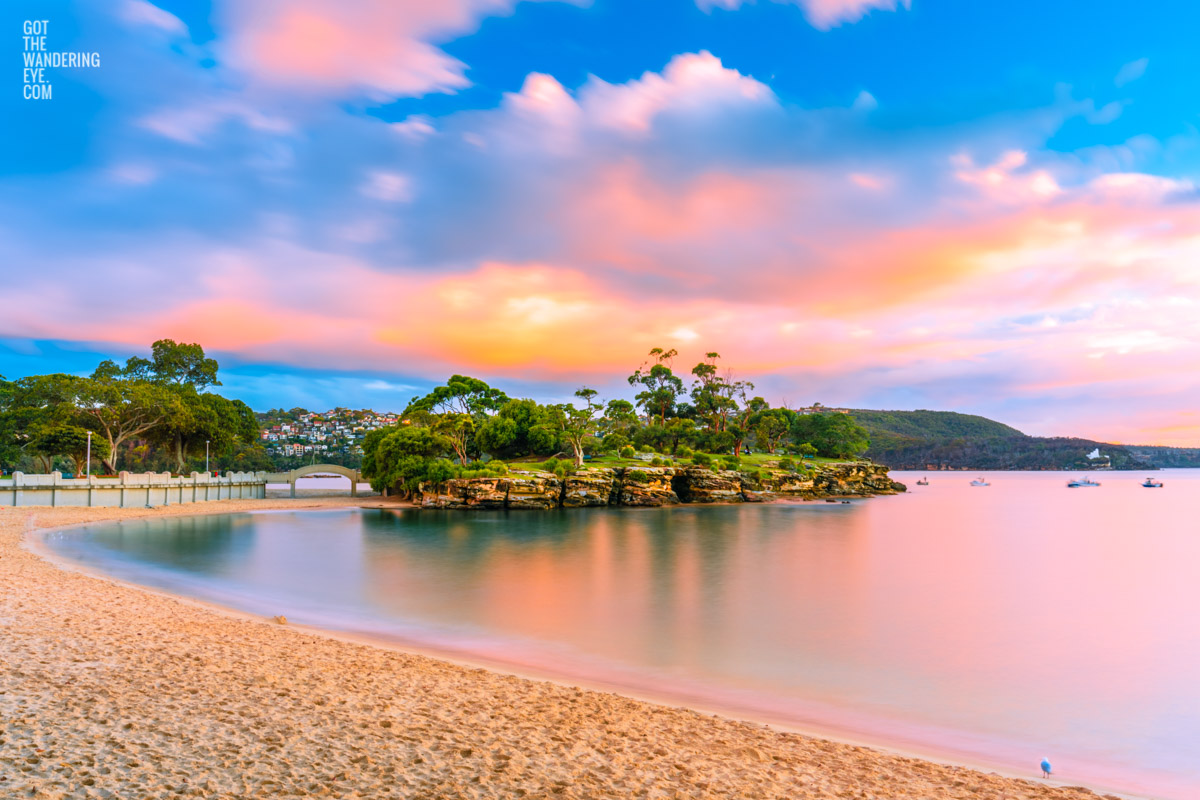 Rocky Point Island illuminated by a beautiful morning sunrise at Balmoral Beach. Long Exposure photography.