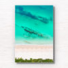 Aerial view above the teal coloured ocean and pure white sand of Hyams beach in Jervis Bay in Summer.