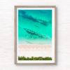 Aerial view above the teal coloured ocean and pure white sand of Hyams beach in Jervis Bay in Summer.