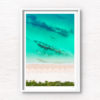 Aerial view above the teal coloured ocean and pure white sand of Hyams beach in Jervis Bay in Summer.