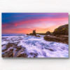 Long exposure of waves crashing over the rocks during a pink sky sunrise at Cathedral Rocks, Kiama Downs.