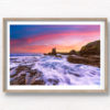 Long exposure of waves crashing over the rocks during a pink sky sunrise at Cathedral Rocks, Kiama Downs.