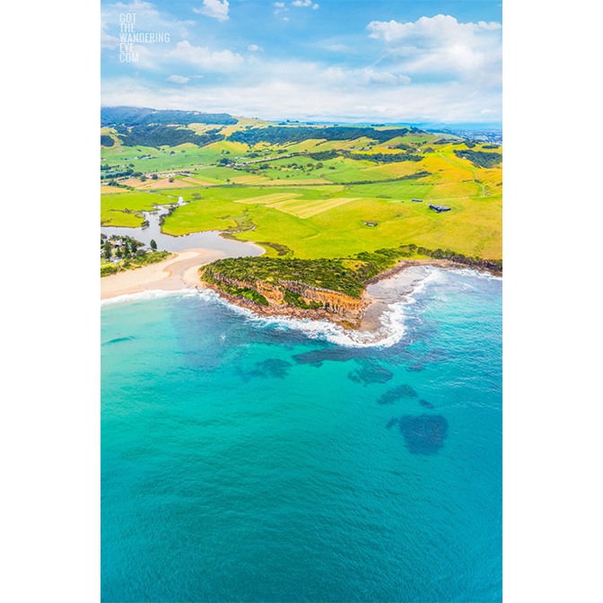 Aerial view above Gerringong north headland at Werri Beach looking back towards Saddleback Mountain.