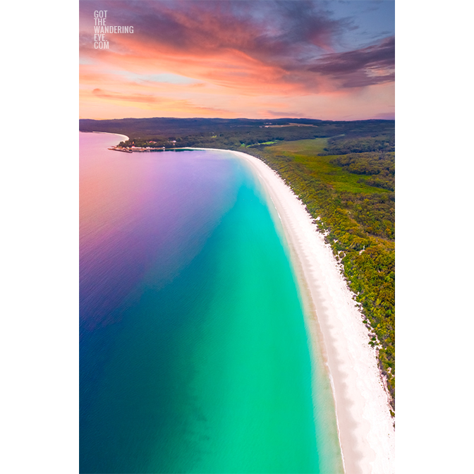 Beautiful view sunrise view above the idyllic white sand beach of Hyams Beach in Jervis Bay. Golden sunlight kissing the teal ocean.