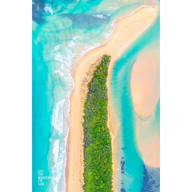 Aerial above mystics beach and Minnamurra River. Flowing teal ocean flowing and connecting at the sand spit towards Rangoon Island