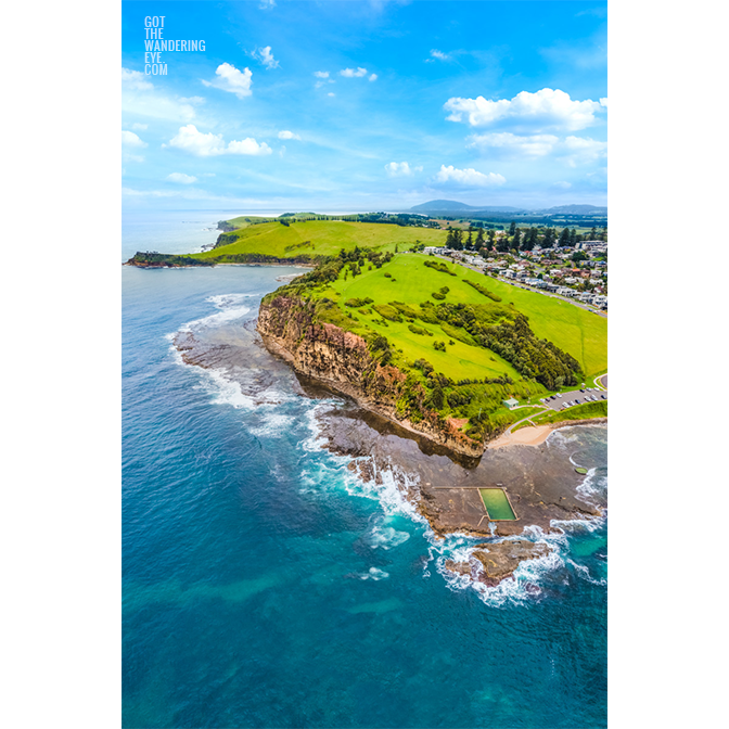 Aerial view above the southern coastline of Werri Beach. High above Ourie Ocean Pool and Gerringong headland.