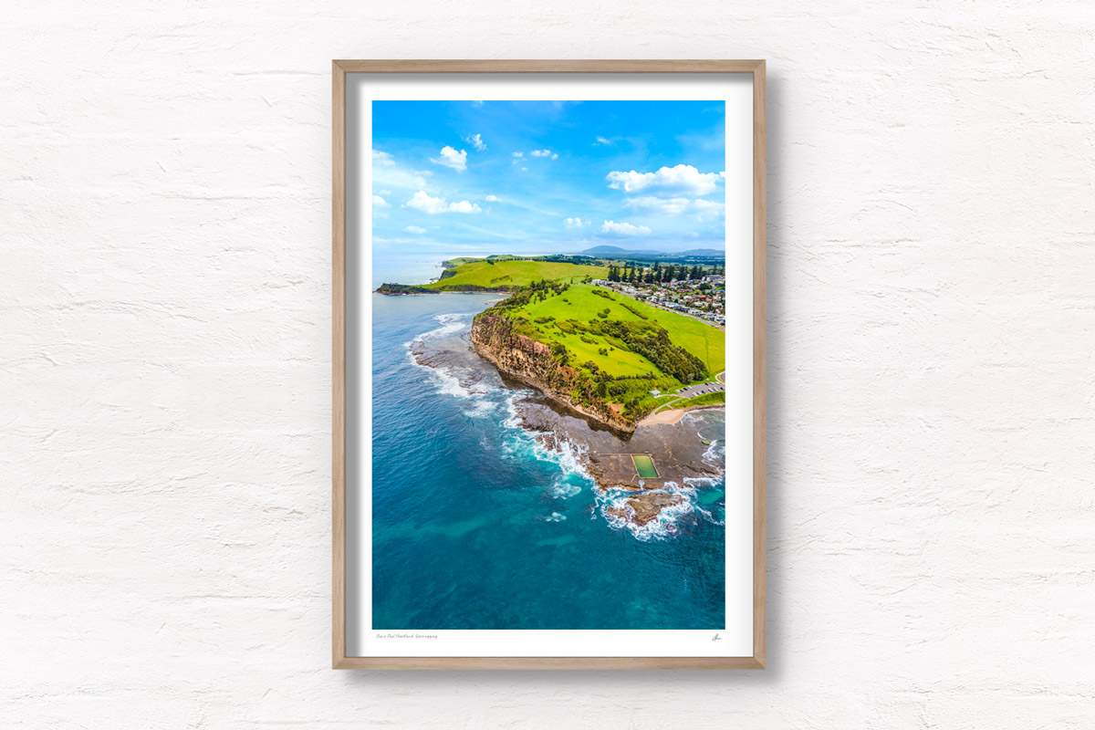 Aerial view above the southern coastline of Werri Beach. High above Ourie Ocean Pool and Gerringong headland.
